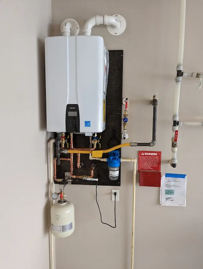 Professional plumber installing copper piping in a Bennett home